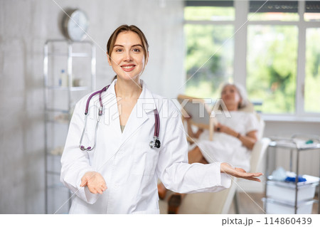 Portrait of young female doctor in scrub. Portrait of young female doctor in scrub. 114860439