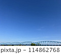 綺麗な青空の下の方に、水色の橋が長く架かっている風景 114862768