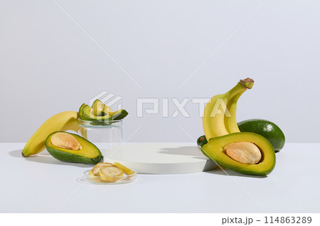 Template to design advertising images for health care or beauty products derived from natural fruits such as avocado and banana, a blank platform in white color for presentation, copy space Template to design advertising images for health care or beauty products derived from natural fruits such as avocado and banana, a blank platform in white color for presentation, copy space 114863289