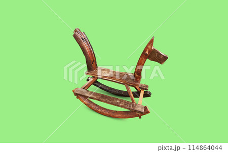 wooden rocking horse on green background 114864044