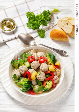chicken meatball soup with vegetables in a bowl 114864541