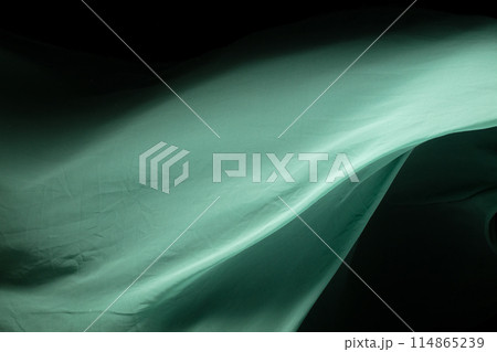 Green Organza fabric flying in curve shape, Piece of textile Green Organza fabric throw fall in air. Black background isolated, dark shading environment Green Organza fabric flying in curve shape, Piece of textile Green Organza fabric throw fall in air. Black background isolated, dark shading environment 114865239