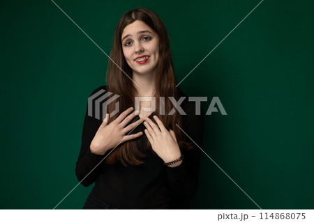 Woman Standing in Front of Green Wall Woman Standing in Front of Green Wall 114868075