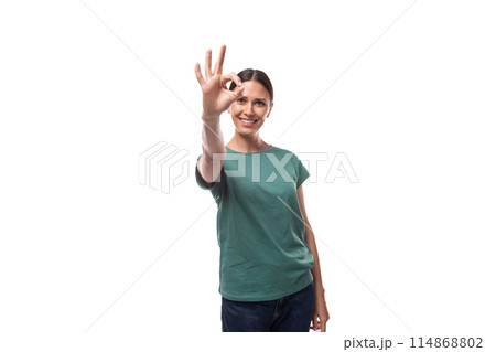 young brunette woman in love with collected hair is dressed in a basic t-shirt and jeans young brunette woman in love with collected hair is dressed in a basic t-shirt and jeans 114868802