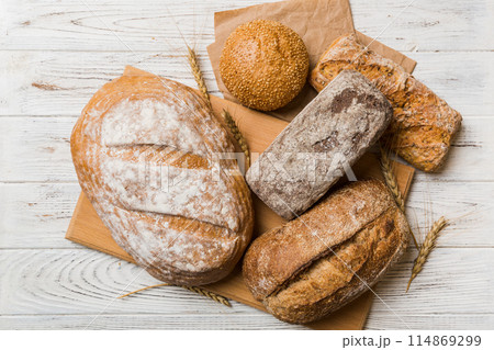 Assortment of freshly baked bread with napkin on rustic table top view. Healthy unleavened bread. French bread 114869299