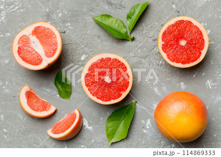 fresh Fruit grapefruit with Juicy grapefruit slices on colored background. Top view. Copy Space. creative summer concept. Half of citrus in minimal flat lay with copy space fresh Fruit grapefruit with Juicy grapefruit slices on colored background. Top view. Copy Space. creative summer concept. Half of citrus in minimal flat lay with copy space 114869333