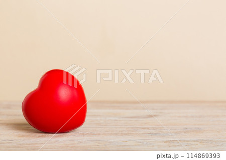 gift box with red bow and red heart on colored background. Perspective view. Flat lay 114869393