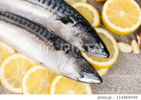 Uncooked mackerel sea fish with lemons and garlic, culinary recipe 114869449