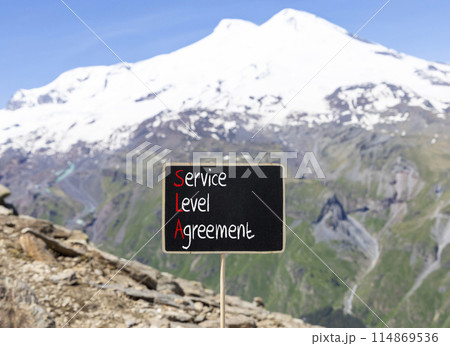 SLA service level agreement symbol. Concept words SLA service level agreement on beautiful yellow blackboard. Beautiful Elbrus background. Business SLA service level agreement concept. Copy space. SLA service level agreement symbol. Concept words SLA service level agreement on beautiful yellow blackboard. Beautiful Elbrus background. Business SLA service level agreement concept. Copy space. 114869536