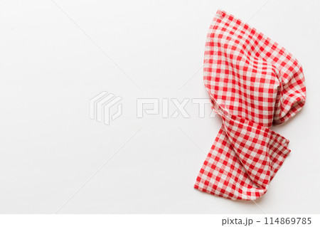 top view with red empty kitchen napkin isolated on table background. Folded cloth for mockup with copy space, Flat lay. Minimal style 114869785