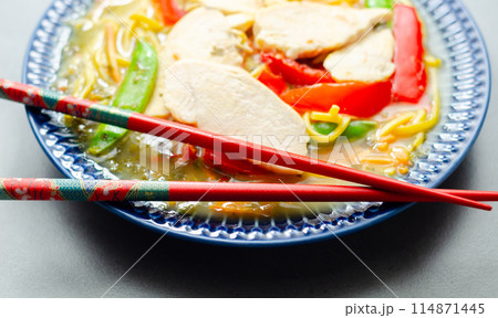 Chicken broth with ginger and black fungus mushrooms, high protein wheat noodles, sliced steamed chicken breast, julienne carrot 114871445