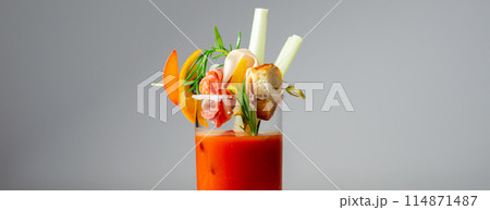 A glass of Bloody Mary drink with a celery spear and an orange slice on top 114871487