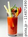 A glass of Bloody Mary drink with a celery spear and an orange slice on top 114871490