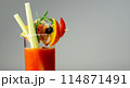 A glass of Bloody Mary drink with a celery spear and an orange slice on top 114871491
