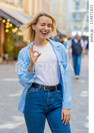 Young woman looking approvingly at camera showing OK gesture positive like sign Okay celebrate win Young woman looking approvingly at camera showing OK gesture positive like sign Okay celebrate win 114871825
