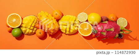 Set of tropical fruit on orange background, top view Set of tropical fruit on orange background, top view 114872930