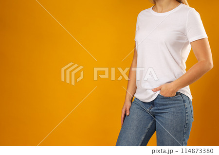 A young woman in a white T-shirt A young woman in a white T-shirt 114873380
