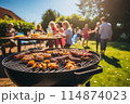 People having a barbecue in the backyard, enjoying food and company 114874023