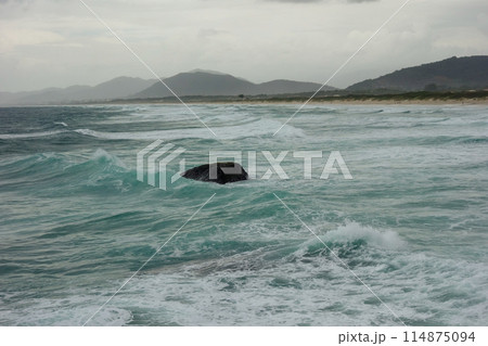 ocean waves crash against rocks on the coast during storm ocean waves crash against rocks on the coast during storm 114875094