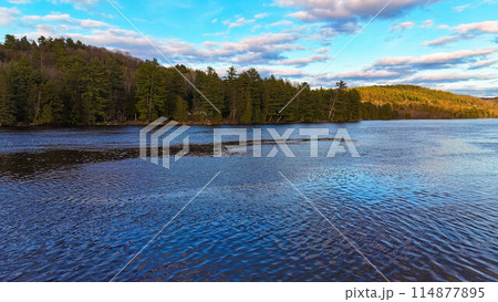 Typical Canadian landscape a lake surrounded by pine trees Typical Canadian landscape a lake surrounded by pine trees 114877895