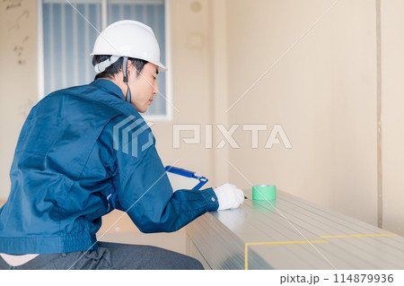 建設現場で資材の確認をする大工 114879936