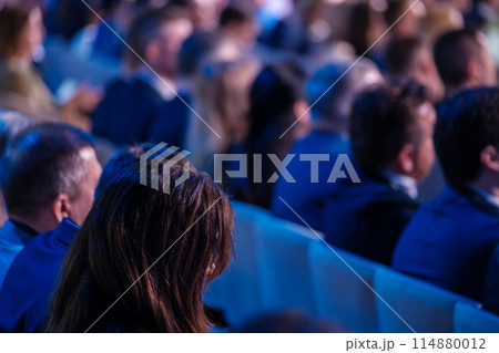 Audience at corporate event listening to presentations Audience at corporate event listening to presentations 114880012