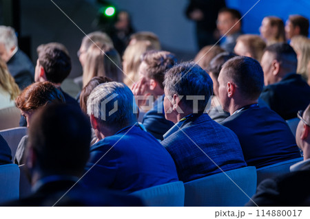 Audience members attentively listening at a corporate conference Audience members attentively listening at a corporate conference 114880017