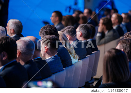 Audience at corporate event listening attentively to speaker 114880047