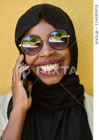 Digital Connection: Close-up Portrait of a Middle Eastern Teenage Muslim Girl Using Smartphone Digital Connection: Close-up Portrait of a Middle Eastern Teenage Muslim Girl Using Smartphone 114880439