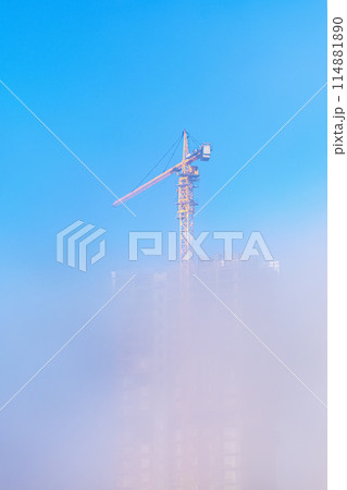Construction crane in heavy fog. Building a house Construction crane in heavy fog. Building a house 114881890