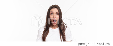 Close-up portrait of surprised and startled young brunette female drop jaw from spilled tea, gossiping and hear something incredible, open mouth fascinated looking camera impressed 114881960
