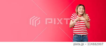 Impressed tender asian silly blond girl amazed describe fascinating performance, woman press palms chest smiling speechless adore cool gift, feed grateful and appreciation, stand red background 114882007