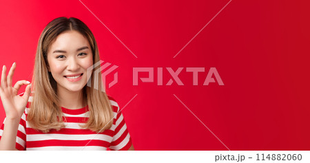 Close-up friendly satisfied carefree young asian blond girl show approval judgement sign okay ok, agree plan good smiling broadly like your idea satisfied great choice, stand red background glad Close-up friendly satisfied carefree young asian blond girl show approval judgement sign okay ok, agree plan good smiling broadly like your idea satisfied great choice, stand red background glad 114882060