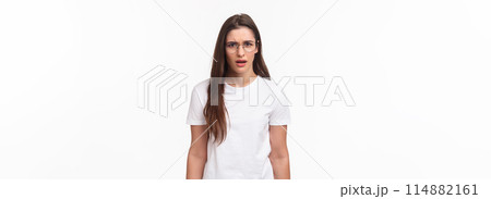 Waist-up portrait of frustrated and shocked young female coworker hear strange confession, freak out, frowning and grimaccing tensed and disappointed, dont agree and like idea, white background 114882161
