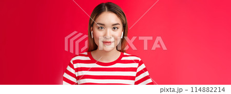 Close-up glamour attractive modern asian blond girl wear wireless white earphones smiling pleased, listening music headphones, enjoy perfect sound new earbuds, stand red background casually Close-up glamour attractive modern asian blond girl wear wireless white earphones smiling pleased, listening music headphones, enjoy perfect sound new earbuds, stand red background casually 114882214