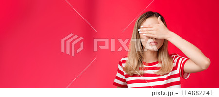 Serious-looking intense asian woman cover sight, hold palm on eyes unwilling see bad scene look focused tensed and pressured standing red background awaiting something happen Serious-looking intense asian woman cover sight, hold palm on eyes unwilling see bad scene look focused tensed and pressured standing red background awaiting something happen 114882241