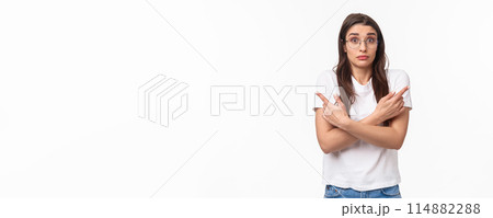 Waist-up of indecisive, clueless good-looking caucasian female in glasses, cant decide, pointing fingers sideways left and right, shrugging and looking confused, asking for help in taking decision Waist-up of indecisive, clueless good-looking caucasian female in glasses, cant decide, pointing fingers sideways left and right, shrugging and looking confused, asking for help in taking decision 114882288