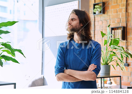 Portrait of young confident handsome man with crossed arms, profile view Portrait of young confident handsome man with crossed arms, profile view 114884128