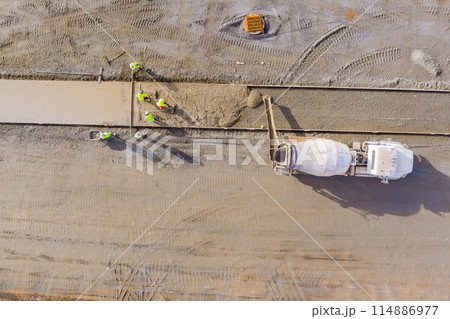 Pouring concrete from mixer machine truck for sidewalk footpath Pouring concrete from mixer machine truck for sidewalk footpath 114886977