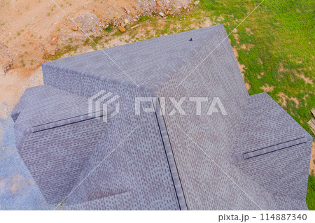 In construction phase of new house, roof is covered with rubber asphalt roof shingles In construction phase of new house, roof is covered with rubber asphalt roof shingles 114887340