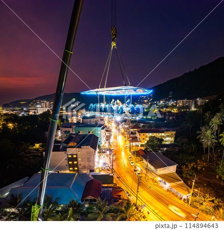 Aerial view of a dinner in the sky in Karon, Phuket, Thailand Aerial view of a dinner in the sky in Karon, Phuket, Thailand 114894643