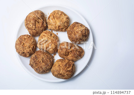 Indian famous tea snacks ooty varkey pastry on white plate on a white background. 114894737