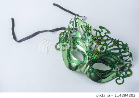 Green carnival mask isolated on white background Green carnival mask isolated on white background 114894802