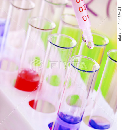Set of test tubes with blue and red liquid on the desktop. Set of test tubes with blue and red liquid on the desktop. 114894834