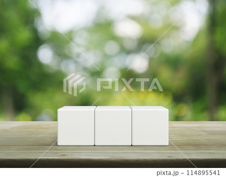 Three white block cubes on wooden table 114895541