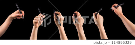 Hand holding digital graphic pen and drawing something isolated on black Hand holding digital graphic pen and drawing something isolated on black 114896329