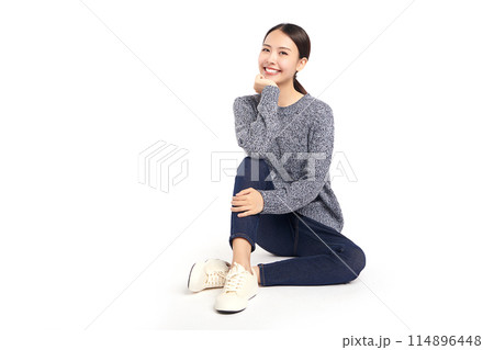 Beautiful young asian woman smiling happy and sitting on the floor on white background, Young female girl with a perfect smile. Beautiful young asian woman smiling happy and sitting on the floor on white background, Young female girl with a perfect smile. 114896448