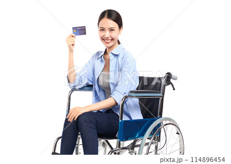Beautiful young asian women with happy smiling and show credit card in a wheelchair on white background, healthcare concept, accident, insurance, life insurance, wellness, hospital. Beautiful young asian women with happy smiling and show credit card in a wheelchair on white background, healthcare concept, accident, insurance, life insurance, wellness, hospital. 114896454