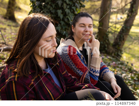 two young women in the forest, tourism, enjoying nature two young women in the forest, tourism, enjoying nature 114897340