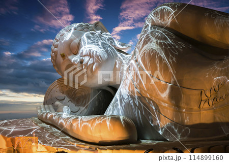 Nirvana white marble reclining Buddha, beautiful sky background. 114899160